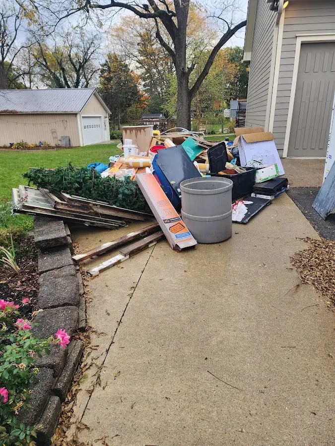 Dumpster being loaded with debris for Roofing Dumpster Rental in Inverness Highlands South